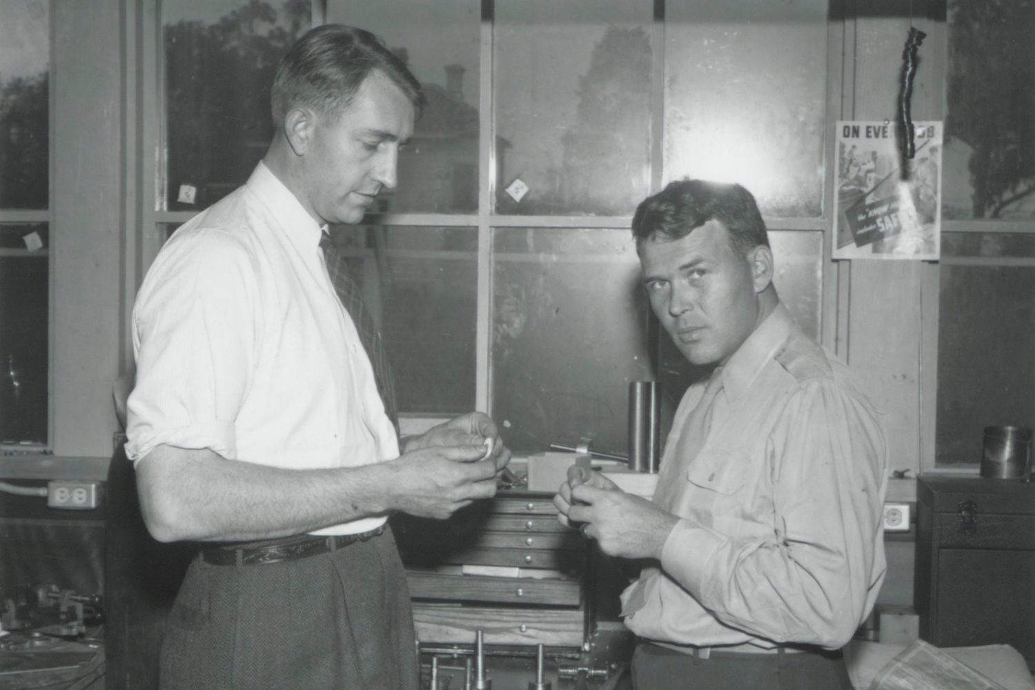 Photo of Dave Packard and Bill Hewlett working at a workbench in the 1940s.