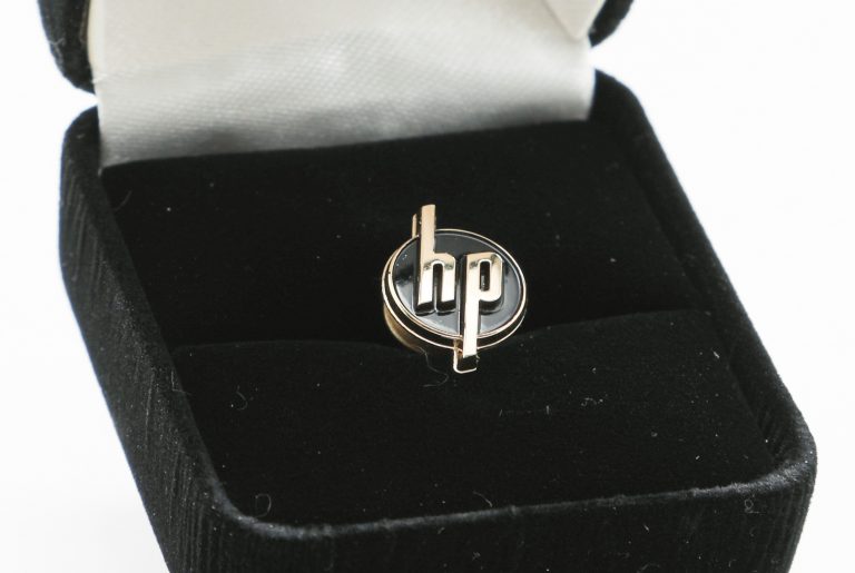 Pin with the HP logo in its box created for the 20th anniversary of the logo in 1966.