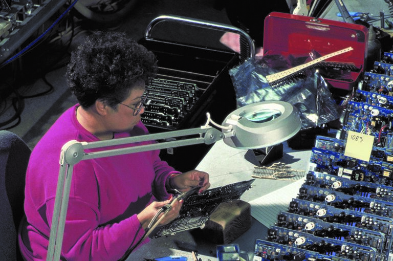 A woman works on a circuit board at the Roseville manufacturing facility in 1993.