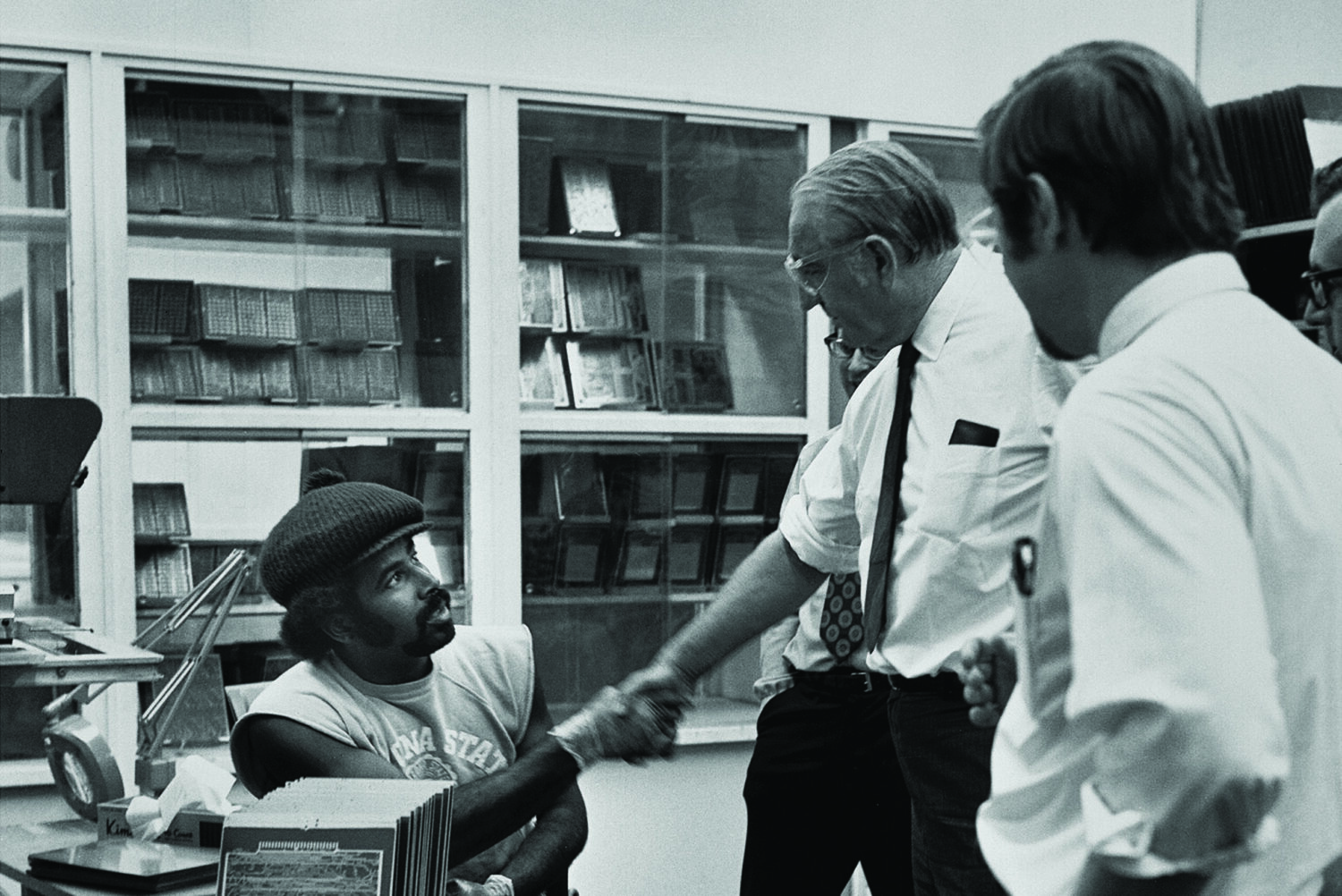 Photo of Dave Packard speaking with an employee in 1974.