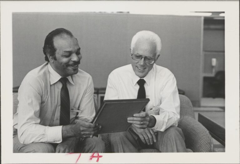 Harry Portwood (left) and Ken Capen (right) admiring the Corporate Commitment Award.