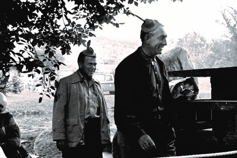 Bill Hewlett and Dave Packard wearing tiny hats during a skit at the dedication of HP Loveland in 1962.