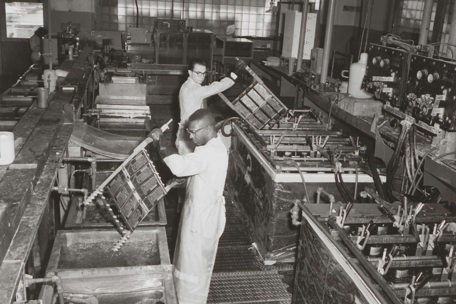 Two HP employees in Palo Alto dip-soldering circuits in the Palo Alto production facility in the 1950s.