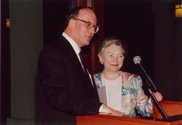 Lew Platt standing at a podium and speaking into a microphone.