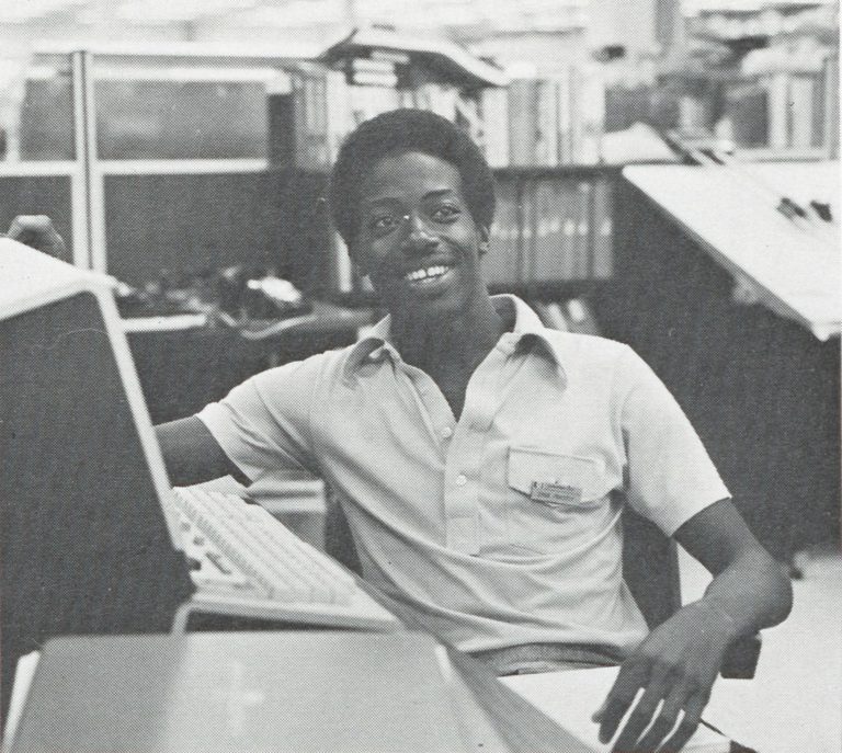 Photo of Ernest Priestly in front of a workstation taken in 1978.